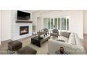 Inviting living room with a cozy fireplace, large windows, and comfortable seating area at 1228 Sage Pine Cir # 12, Clover, SC 29710
