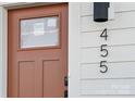 Close-up of the front door and address of a modern townhouse, featuring a sleek design and contrasting colors at 455 Blairhill Rd # 03, Charlotte, NC 28217