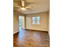 Simple bedroom with wood-look floors and access to patio at 3178 Heathstead Pl, Charlotte, NC 28210