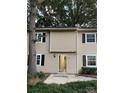 Tan two-story townhouse with a visible entrance and landscaping at 3178 Heathstead Pl, Charlotte, NC 28210