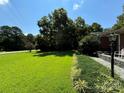 Lush front yard featuring manicured landscaping that leads to a charming brick home at 4549 Nc Highway 109 N Hwy, Troy, NC 27371