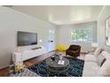 Bright living room featuring hardwood floors, stylish furniture, and a large window at 3245 Minnesota Rd, Charlotte, NC 28208