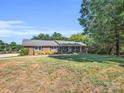 Charming brick ranch home with a well-maintained lawn and mature landscaping at 3039 Longwood Dr, Shelby, NC 28152