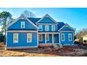 Two-story blue house with white trim, covered porch, and large windows at 332 Canvasback Rd, Mooresville, NC 28117