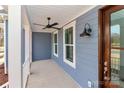 Inviting front porch featuring stylish lighting, ceiling fan, and views of the front yard at 332 Canvasback Rd, Mooresville, NC 28117