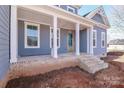 Covered front porch with brick steps and wooden columns at 332 Canvasback Rd, Mooresville, NC 28117