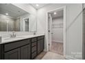 Bathroom with double vanity, walk-in shower, and closet at 335 Bezelle Ave, York, SC 29745