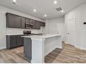 Modern kitchen with dark cabinetry, quartz countertops, and island at 335 Bezelle Ave, York, SC 29745