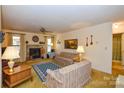 Inviting living room featuring a fireplace, ceiling fan, and natural light at 102 Cedar Hollow St, Fort Mill, SC 29715