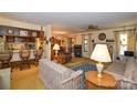 Open-concept living space with a view of the kitchen, dining area, and fireplace at 102 Cedar Hollow St, Fort Mill, SC 29715