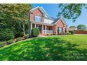 Brick house with a front porch and well maintained lawn at 2594 Knoll Ridge Ct, Hickory, NC 28602