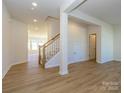Open concept entryway with hardwood floors and staircase to upper level at 10509 Boudreaux St, Huntersville, NC 28078