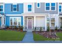 Townhome entry featuring a purple door and stone accents at 10509 Boudreaux St, Huntersville, NC 28078