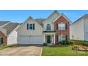 Two story brick and siding home with two car garage at 11407 Sidney Crest Ave, Charlotte, NC 28213