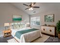 Bright bedroom with a ceiling fan, a large window, and stylish decor and furnishings at 6427 Saint Bernard Way, Charlotte, NC 28269