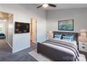 Comfortable bedroom featuring modern furnishings, a ceiling fan, and a mounted television at 6427 Saint Bernard Way, Charlotte, NC 28269