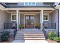 Inviting front porch with double doors and stone steps at 859 Irish Creek Dr, Landis, NC 28088