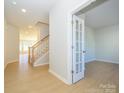 Open concept hallway with hardwood floors, and access to office and stairs at 10513 Boudreaux St, Huntersville, NC 28078
