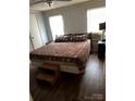 Spacious bedroom with a large bed and dark floors at 735 Ned Marsh Rd, Salisbury, NC 28146