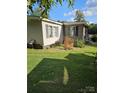 Side view of a mobile home with landscaping at 735 Ned Marsh Rd, Salisbury, NC 28146