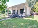 Updated bungalow exterior, featuring a covered porch and well-maintained lawn at 818 N Jackson St, Salisbury, NC 28144