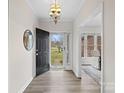 Inviting entryway with wood floors, an open door and a view to the formal dining room at 1823 Southridge Dr, Belmont, NC 28012