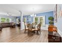 Open dining room with glass table, hardwood floors, and access to living room at 7223 Meyer Rd, Fort Mill, SC 29715