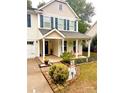 Front porch of a two-story house with landscaping and seasonal decor at 7223 Meyer Rd, Fort Mill, SC 29715