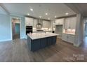 Spacious kitchen featuring a large island, white cabinets, and stainless steel appliances at 3229 Mcharney Dr # 30, Harrisburg, NC 28075