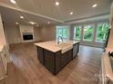 Gourmet kitchen with central island, stainless steel appliances, and an open layout to the living area at 3229 Mcharney Dr # 30, Harrisburg, NC 28075