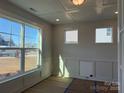 Bright living room with large windows, hardwood floors, and decorative trim details, offering a versatile space at 3229 Mcharney Dr # 30, Harrisburg, NC 28075