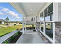 Inviting covered front porch with decorative stone accents and manicured landscaping at 3229 Mcharney Dr # 30, Harrisburg, NC 28075
