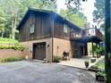 Charming home featuring a brick and wood exterior, a garage, and a spacious outdoor patio at 460 27Th Avenue Nw Cir, Hickory, NC 28601