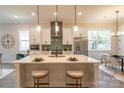 Open concept kitchen with white cabinets, island, and stainless steel appliances at 2630 Rose St, Charlotte, NC 28208