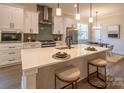 Modern kitchen with white cabinets, center island, and stainless steel appliances at 2630 Rose St, Charlotte, NC 28208