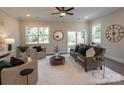 Inviting living room with modern furnishings, a cozy rug, and ample natural light from large windows and sliding glass door at 2630 Rose St, Charlotte, NC 28208