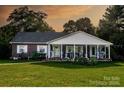 Beautiful brick home with a large, inviting front porch perfect for relaxing and enjoying the outdoors at 3021 Davis Park Rd, Gastonia, NC 28052