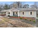 Newly renovated ranch home with gray siding, brick accents, and a welcoming front yard at 16 Hill St, York, SC 29745