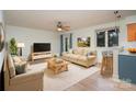 Living room with beige sofas, a TV, and a kitchen bar at 2423 Vail Ave # A12, Charlotte, NC 28207