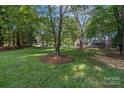 Spacious backyard with mature trees and lush green grass at 8503 Foxbridge Dr # 16, Matthews, NC 28104