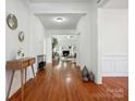 Hardwood floor entryway, open to living room with fireplace at 9667 Laurie Nw Ave, Concord, NC 28027