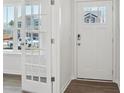 Bright entryway featuring hardwood floors, a white front door with glass panes, and French doors leading to another room at 112 Rustling Waters Dr, Mooresville, NC 28117