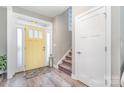 Bright entryway features stylish yellow door, gray walls, and warm wood-look floors at 236 Pinnacle Xing, Shelby, NC 28152