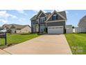 Charming two-story home featuring a well-manicured lawn and an attached two-car garage at 236 Pinnacle Xing, Shelby, NC 28152