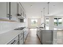 Modern kitchen featuring gray cabinets, white countertops, stainless appliances, and a central island with sink at 97 Seven Oaks Lndg, Belmont, NC 28012