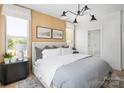 Bright bedroom featuring a cozy bed, modern lighting, and elegant wall decor at 1340 Hamilton St # 3, Charlotte, NC 28206