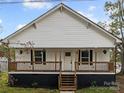 Renovated white house with a front porch and landscaped yard at 225 York Ave, Kannapolis, NC 28083