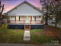 Charming white house with a front porch and well-manicured lawn at 225 York Ave, Kannapolis, NC 28083