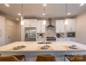 Modern kitchen with white cabinets, stainless steel appliances, and a large island at 621 Seldon Dr, Charlotte, NC 28216