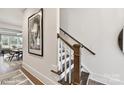 Hallway with hardwood floors, stairs with wooden railings, and an arched doorway view of the living area at 5051 Elm View Dr # 26, Charlotte, NC 28277